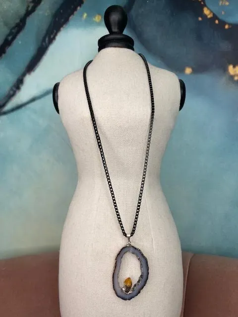 Robyn Rhodes Necklace that is an Oval Grey Agate interior lines with Clear and Black Druzy including a Citrine nugget