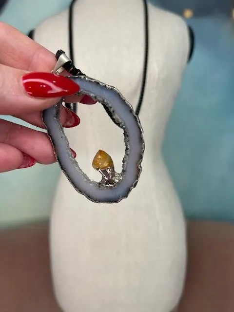 Robyn Rhodes Necklace that is an Oval Grey Agate interior lines with Clear and Black Druzy including a Citrine nugget